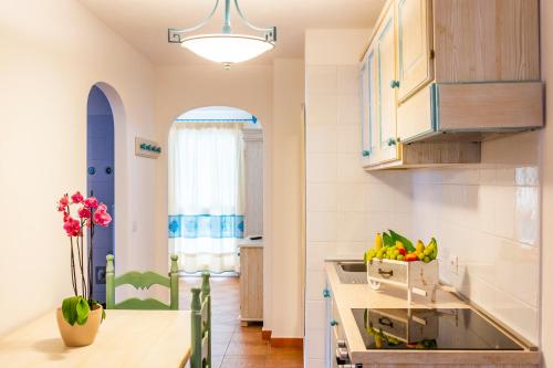 a kitchen with a counter with a bowl of fruit at Le Residenze del Baia Marina in Orosei