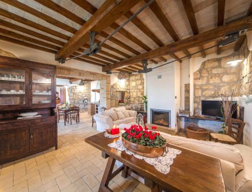 a living room with a couch and a table at Villa I Calanchi Di Civita in Bagnoregio