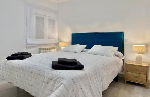Un dormitorio con una cama grande con dos toallas encima. en Serena Arte, en Zaragoza
