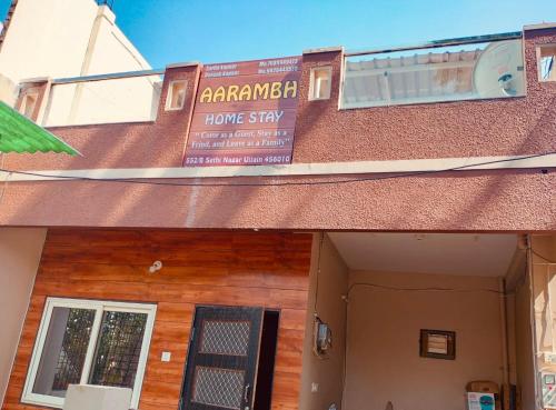 a building with a sign for a home stay at Aarambh Homestay in Ujjain