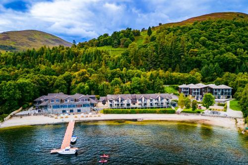 an aerial view of a resort on a body of water at The Lodge On Loch Lomond Hotel in Luss