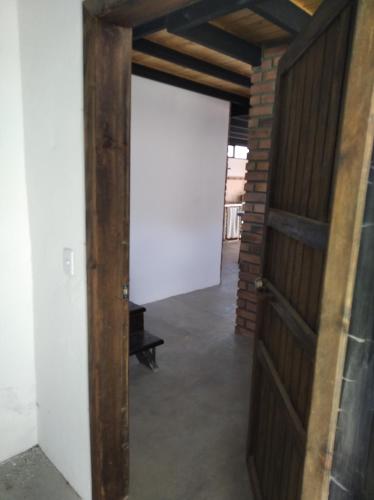 an open door in a room with a brick wall at Posada María E in Mucuchíes