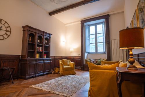 a living room with a couch and chairs and a clock at Residenza Monaldeschi in Orvieto