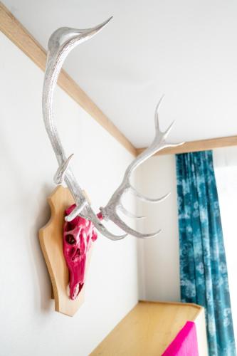 a deer skull hanging from a shelf at Hotel Urania in Vienna