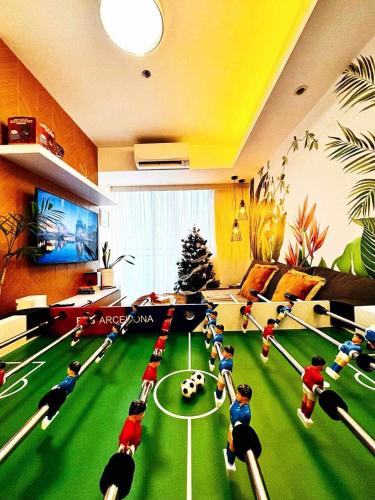 a living room with lego people playing a game of soccer at Holiday Escape Philippines in Manila