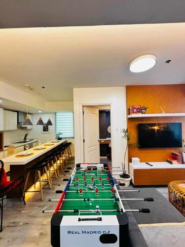 a room with a pool table in the middle at Holiday Escape Philippines in Manila