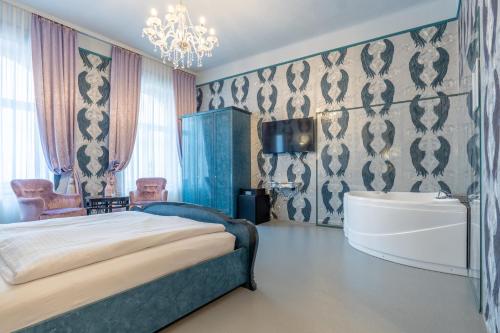 a bedroom with a bed and a tub and a sink at Hotel Urania in Vienna