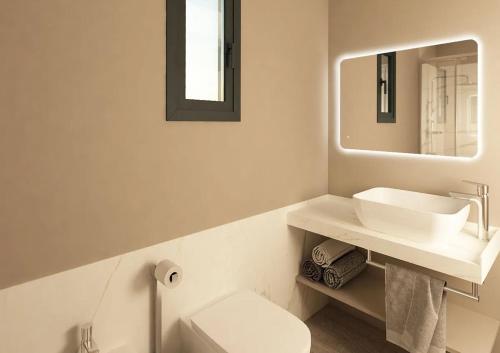a white bathroom with a sink and a mirror at Camping Union Lido in Cavallino-Treporti