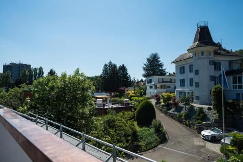 a view of a building and a street with a car at HITrental Wiedikon Apartments in Zürich