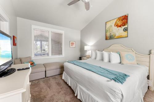 a bedroom with a large white bed and a window at 1369 Laurel Grove "The Crows Nest" in Destin