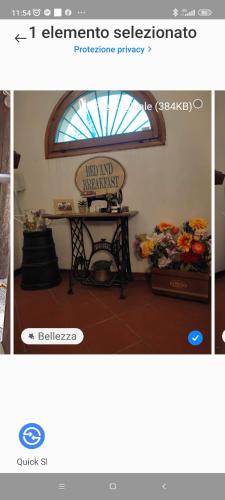 a picture of a room with a table and flowers at B&B DUE ABETI in Florence