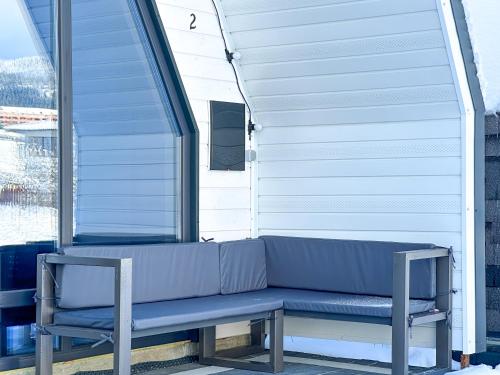 a blue bench sitting in front of a window at Шале WeLKoMe in Verkhovyna