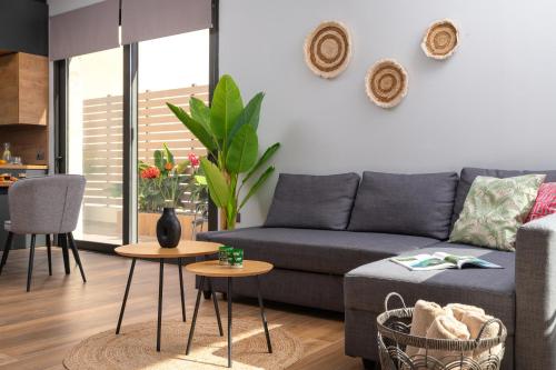 a living room with a couch and a table at La Siesta Villas in Ixia