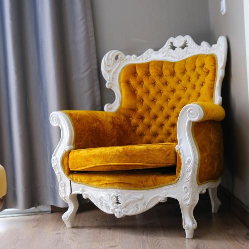 a yellow and white chair sitting in a room at Adana City Boutique Hotel in Adana