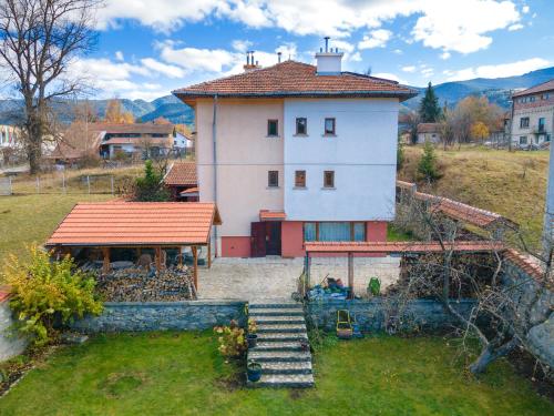 a house with a staircase leading up to it at Cozy Luxurious Apartment Next to Borovets and Rila mountain in Govedartsi