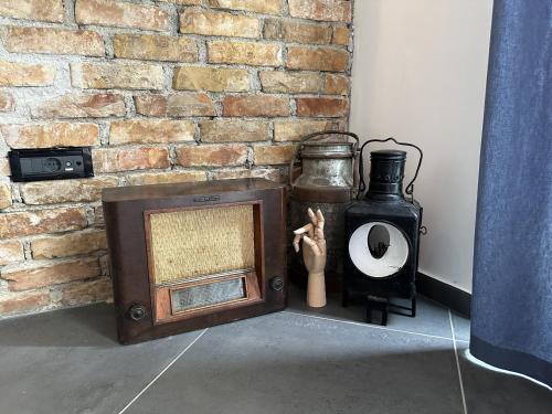 an old tv sitting next to a brick wall at Apartments Urban in Poreč