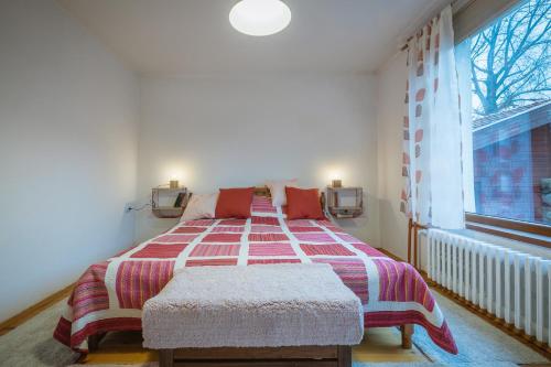 a bedroom with a bed and a large window at Cozy Luxurious Apartment Next to Borovets and Rila mountain in Govedartsi