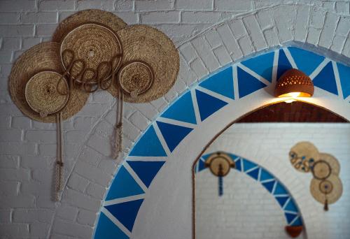 a room with straw hats hanging from a ceiling at Dolty Kato Nubian House By Kato Dool in Aswan