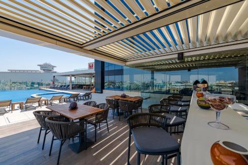 a restaurant with tables and chairs on a roof at Millennium Al Masar in Jeddah