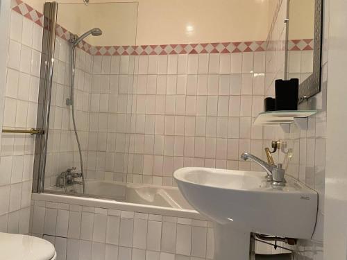une salle de bain avec un lavabo et une baignoire dans l'établissement Appartement vue mer avec accès privé à la plage, à Lecci