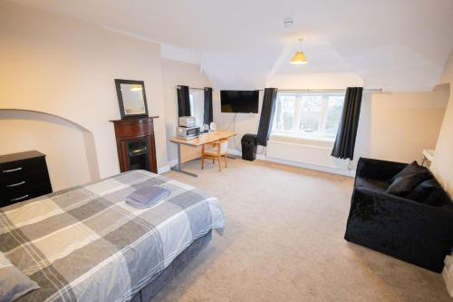 a bedroom with a bed and a desk in it at The Station Hotel in Billingham