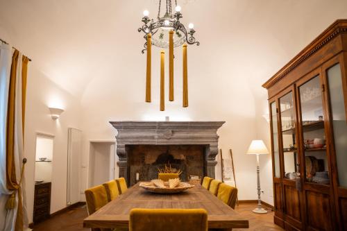 a dining room with a table and a fireplace at Residenza Monaldeschi in Orvieto