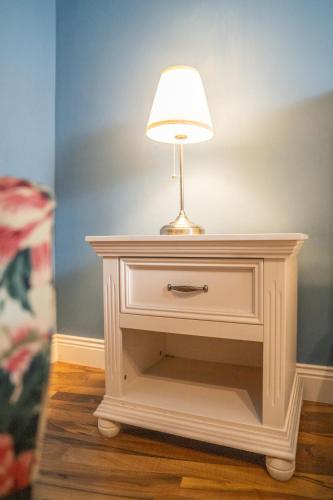 a lamp on top of a white end table at Hotel Urania in Vienna
