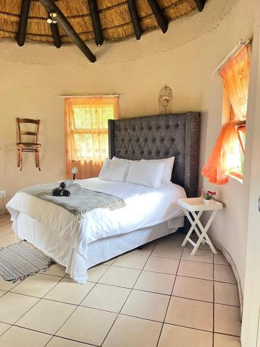a bedroom with a large bed in a room at Indlovu Inn Guesthouse in Graskop