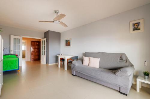 a living room with a couch and a table at Winahost Valencia El Puig 1 in El Puig