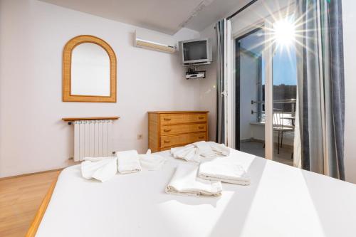 a bedroom with a white bed and a window at Hotel Timun in Gdinj