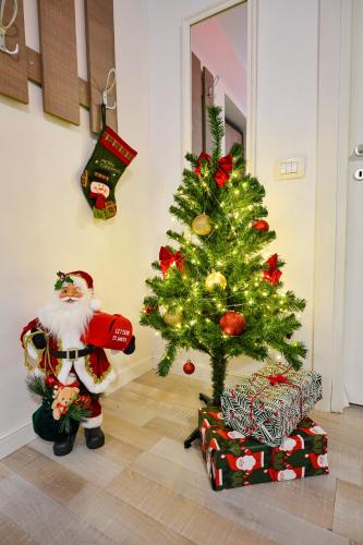 a christmas tree in a room with a santa clause at Bucharest Accommodation Apartments in Bucharest