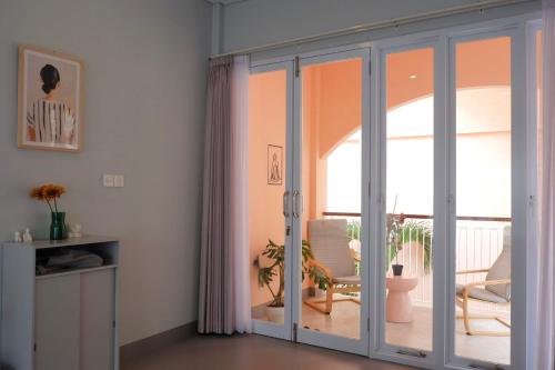 a room with sliding glass doors with a patio at Ponder Bali Canggu in Canggu