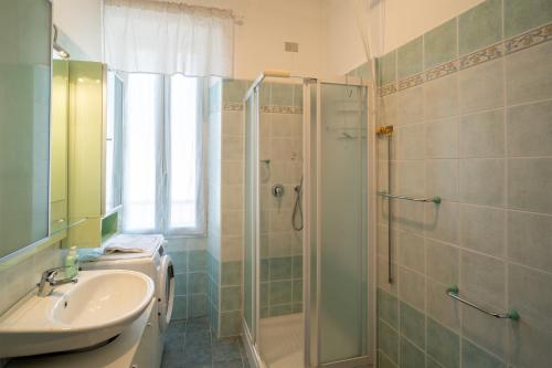 a bathroom with a sink and a shower at Gioberti Flat - WiFi - City Center - Shopping Street - Casino - Ariston in Sanremo