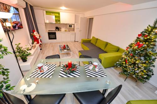 a living room with a table and a christmas tree at Bucharest Accommodation Apartments in Bucharest