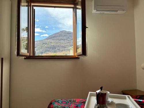 a sink and a window with a view of a mountain at Breva e Tivano - Larihome A54 in Gravedona