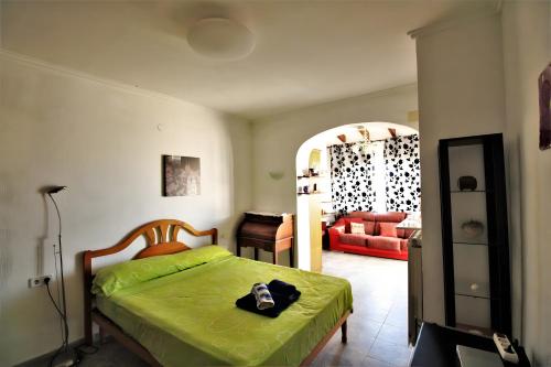 a bedroom with a bed and a living room at Elisabet in Denia