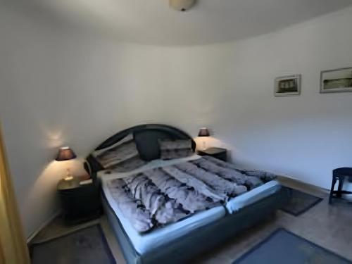 a large bed in a room with two lamps at Bárbara in Pedreguer