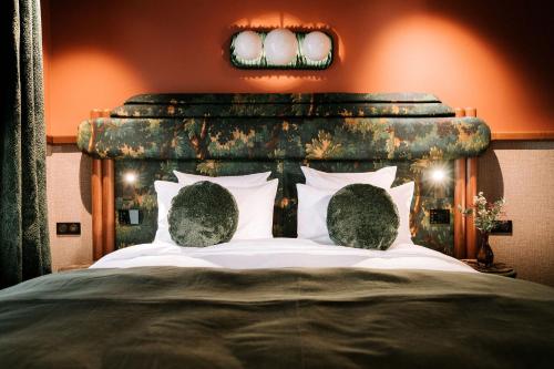 a bedroom with a large bed with a wooden headboard at 1.75 Paris La Trêve in Paris