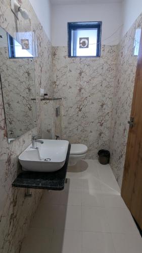 a bathroom with a sink and a toilet at MAHA RAAS A unit of RAAS LEELA Hotels and Resort in Udaipur
