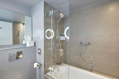 a bathroom with a shower with a glass door at Scandic Frankfurt Museumsufer in Frankfurt/Main