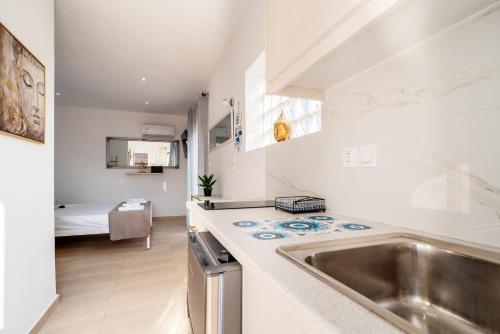 a kitchen with a sink and a counter top at Angelina Studios in Lefkímmi