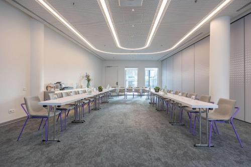 a large room with tables and chairs in it at Park Inn by Radisson Amsterdam City West in Amsterdam