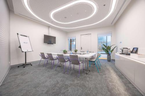 a meeting room with a white table and chairs at Park Inn by Radisson Amsterdam City West in Amsterdam