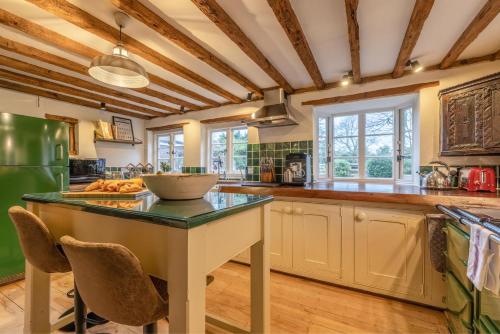 a kitchen with a table with a bowl on it at Cosy 5 Bed Cottage Retreat, Perfect for Families in Buckinghamshire