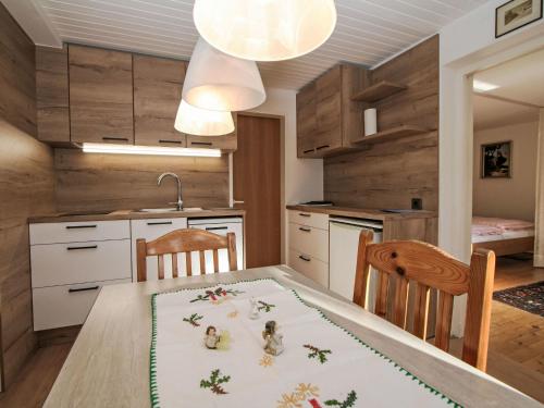 a kitchen with a table and two chairs and a kitchen with a kitchen at Apartment Hannelore by Interhome in Omes