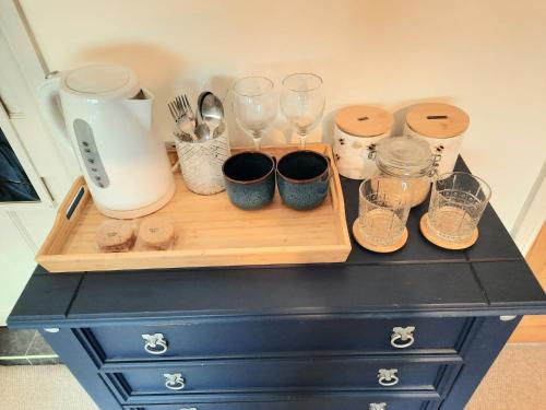 a counter with a cutting board with glasses on it at Super king bedroom with large ensuite in Brighton & Hove