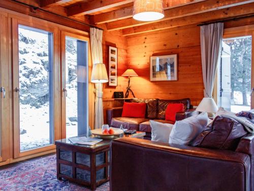 a living room with a couch and a table at Chalet Crettamour by Interhome in Veysonnaz
