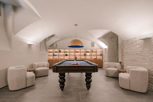 a game room with a pool table and chairs at BoHo Hotel Budapest - Small Luxury Hotels in Budapest