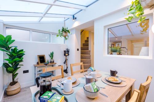 a dining room with a table and chairs at Foden's House by YourStays - 2 Bedroom Cottage in Sandbach with gorgeous dining room extension, High end finish in Sandbach