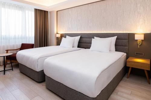 a hotel room with two beds and a table at The Emporia Hotel in Pamukkale